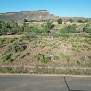 Desert landscape with road and mesa in background